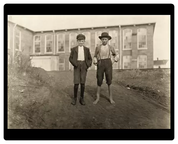HINE: CHILD LABOR, 1908. Two young textile workers standing in front of the Wylie Mill in Chester