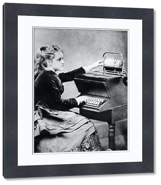 FIRST TYPIST, 1872. Lillian Sholes, the first typist, using a prototype typewriter