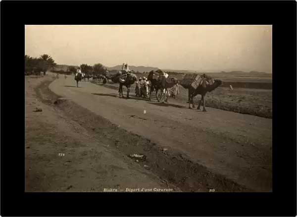 ALGERIA: CAMEL CARAVAN. A camel caravan departing Biskra, Algeria. Photograph, c1875