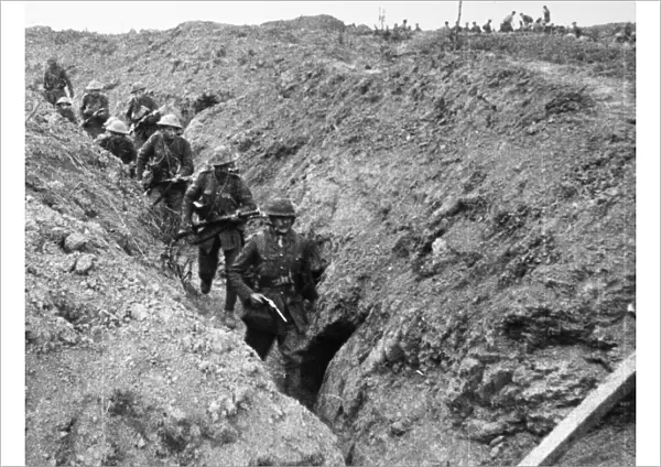BATTLE OF THE SOMME, 1916. Allied troops walking through a captured trench during