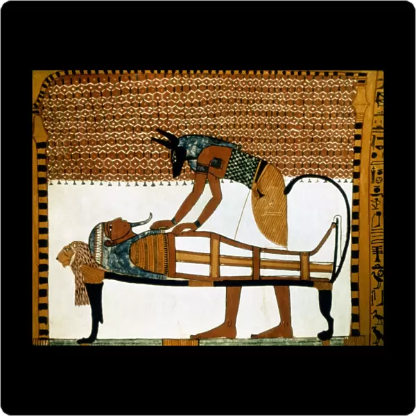 ANCIENT EGYPT: ANUBIS. The god Anubis mummifies a dead body