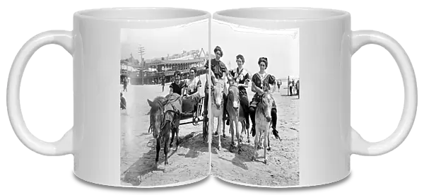 ATLANTIC CITY: BEACH. Three women on donkeys and a young couple in a cart drawn