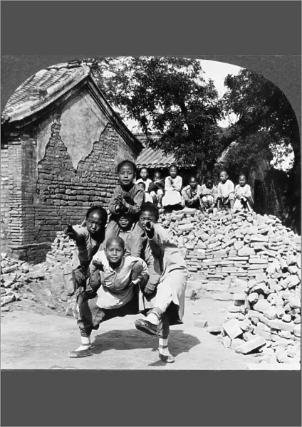 CHINA: CHILDREN, c1925. Chinese children playing the dragons head game outdoors, China