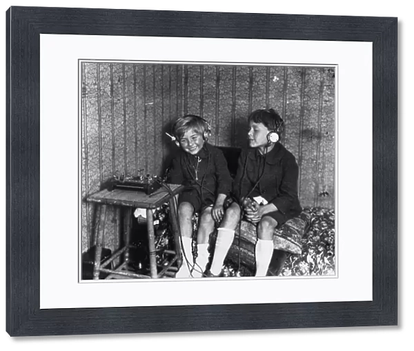 RADIO, c1920. Two boys listening to a radio with headphones. Photograph, c1920