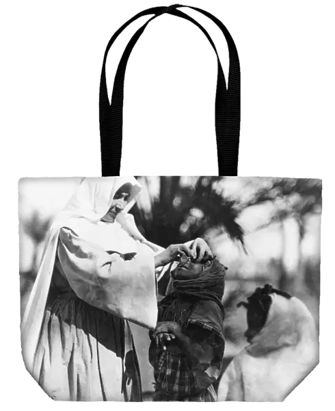 ALGERIA: BLINDNESS, c1920. A sister of the order of the White Nuns of the Sahara