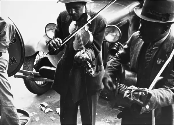 STREET MUSICIANS, 1935. African American street musicians in rural America. Photograph, 1935, by Ben Shahn