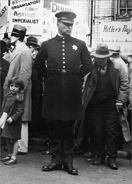 POLICE AND PROTESTERS, 1936. A police officer and protesters at a political gathering