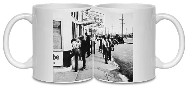 NEW ORLEANS: UNEMPLOYED, 1935. Job applicants waiting outside the offices of the
