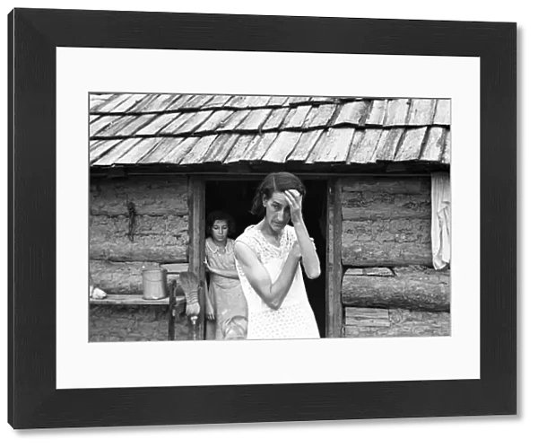 ARKANSAS: SHARECROPPER. A sharecroppers wife and daughter in front of their farmhouse