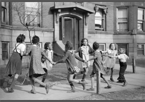 CHICAGO: CHILDREN, 1941. Children playing ring around the rosie in the Black Belt