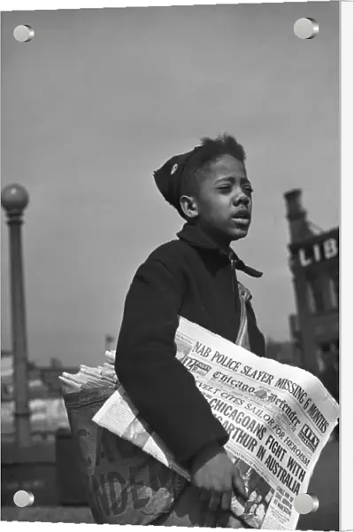 CHICAGO: NEWSBOY, 1942. Newsboy selling the Chicago Defender, a leading African