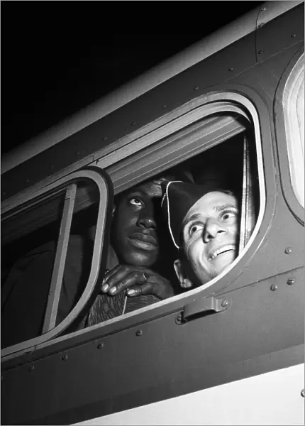 BUS STATION, 1943. Soldiers looking out of the bus window at a Greyhound station in Washington D