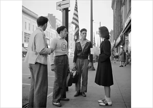 NEW YORK: AMSTERDAM, 1941. Young men and women on the street after school in Amsterdam, New York