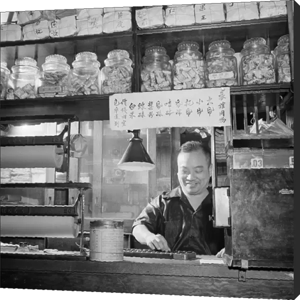 NEW YORK: CHINATOWN, C1942. A man counting on an abacus in a Chinese grocery store in Chinatown