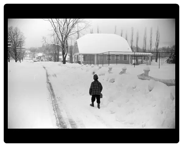 NEW HAMPSHIRE: SNOW, 1940. A boy walking home from school after snowstorm in Jackson