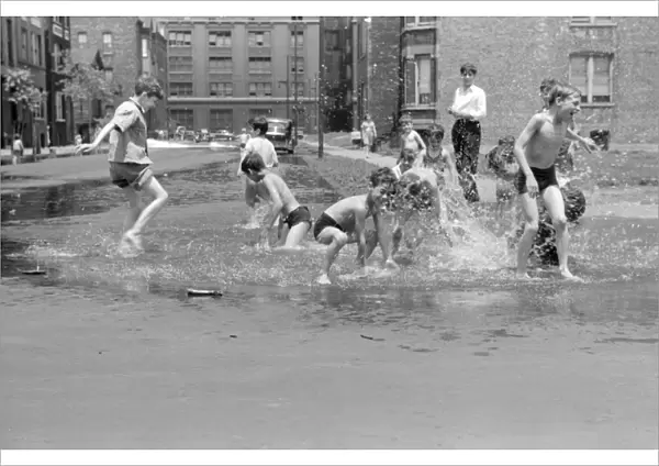 CHICAGO, 1941. Boys playing the the water from a fire hydrant in Chicago, Illinois