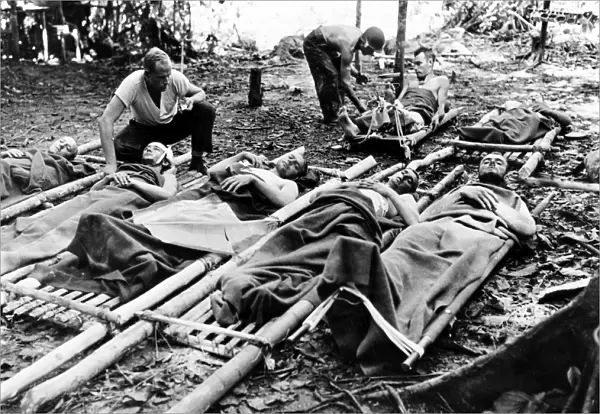 WORLD WAR II: NEW GUINEA. Wounded American soldiers are given medical attention