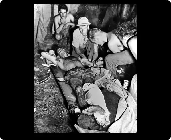 WORLD WAR II: NEW GUINEA. A wounded American soldier receives a blood transfusion