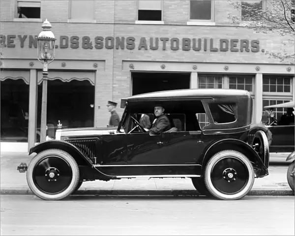 AUTOMOBILE, c1922. An automobile outside of the American company Reynolds & Sons Autobuilders