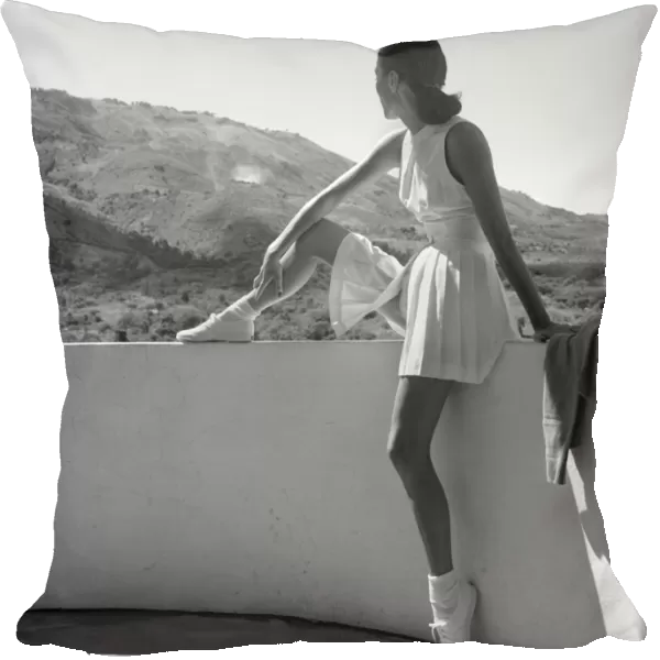 FASHION: TENNIS OUTFIT. A woman wearing a tennis outfit. Photogaphed by Toni Frissell