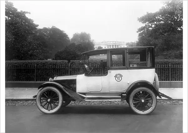 WASHINGTON, DC: TAXI, c1921. A black and white taxi cab outside the White House in Washington, D