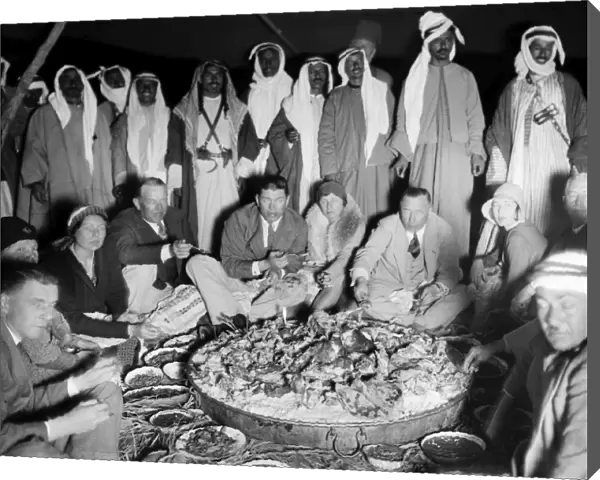 BEDOUIN CAMP, 1931. Several Western couples dining at a Bedouin camp in the Middle East
