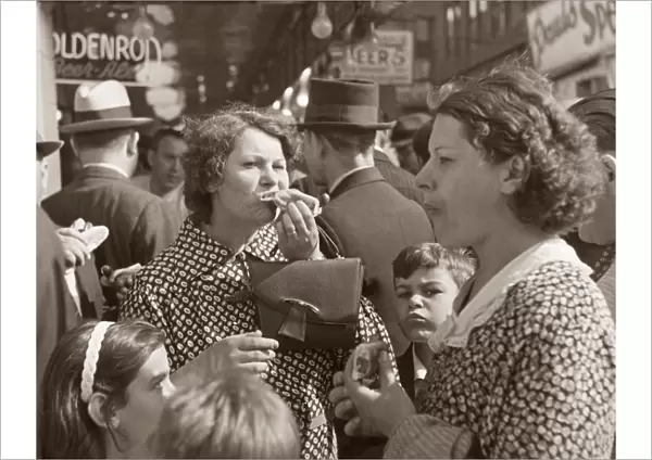 CONEY ISLAND, 1936. Women and children eating hot dog in Coney Island, Brooklyn