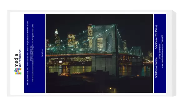 BROOKLYN BRIDGE, 1982. Northwest view of the Brooklyn Bridge and Lower Manhattan at night