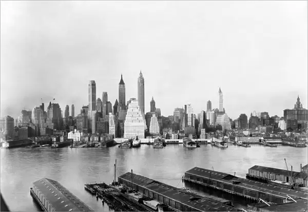 NEW YORK: EAST RIVER, c1931. The East River flows between Brooklyn piers and the Manhattan skyline