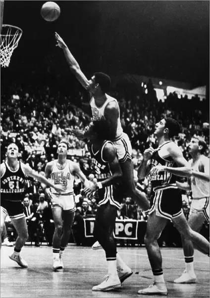 BASKETBALL GAME, 1966. Kareem Abdul Jabbar (Lew Alcindor), playing for UCLA, jumps to make a shot during a game against Southern California, December 1966