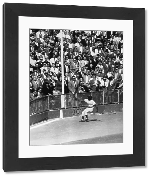 WORLD SERIES, 1955. Left fielder Sandy Amoros of the Brooklyn Dodgers catches a deep fly ball hit by Yogi Berra of the New York Yankees in the sixth inning of the seventh and deciding game of the 1955 World Series, at Yankee Stadium in the Bronx, New York City, 4 October 1955
