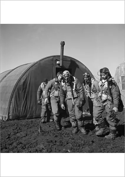 WWII: TUSKEGEE AIRMEN, 1945. Tuskegee Airmen leaving the parachute room at Ramitelli Airfield in Italy, March 1945. Left to right: Richard Harder; unidentified; Thurston Gaines; Newman Golden and Wendell Lucas. Photograph by Toni Frissell