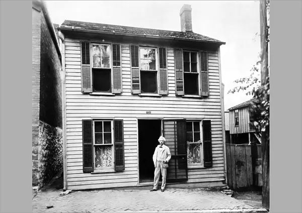 SAMUEL LANGHORNE CLEMENS (1835-1910). Mark Twain. American writer and humorist. Mark Twain photographed at his childhood home in Hannibal, Missouri, 1902
