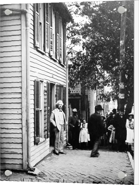 SAMUEL LANGHORNE CLEMENS (1835-1910). Mark Twain. American writer and humorist. Mark Twain photographed at his childhood home in Hannibal, Missouri, 1902