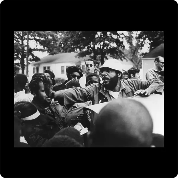 DICK GREGORY (1932- ). American comedian, clearing through a crowd before speaking at Liberty Park in Norfolk, Virginia, while campaigning for president on the Peace and Freedom Party ticket, 18 October 1968