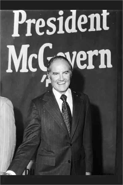 GEORGE McGOVERN (1922- ). American politician. Senator McGovern beneath a poster in New York City, during his presidential campaign, June 1972