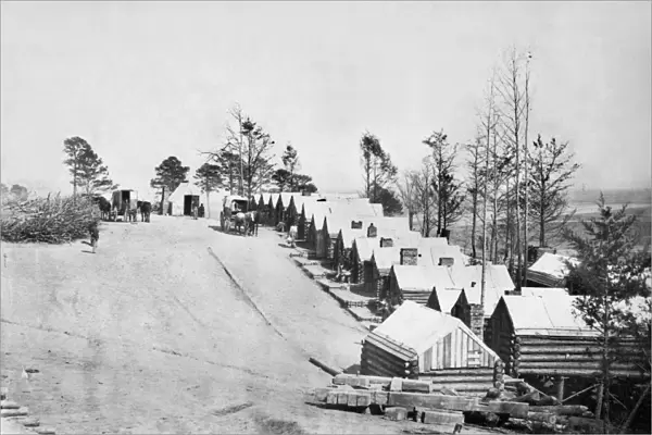 CIVIL WAR: BARRACKS. Log cabins used as barracks for Union Army soldiers at a military facility in Richmond, Virginia. Photograph by Andrew Russell, c1864