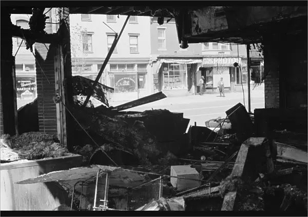 Ruins of a store in Washington, D. C. destroyed during the riots following the assassination of Martin Luther King, Jr. Photographed by Warren Leffler, 16 April 1968