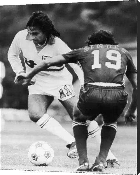 BEST & SIMOES, c1977. George Best of the L. A. Aztecs competes for the ball against Antnio Simes of the San Jose Earthquakes, c1977