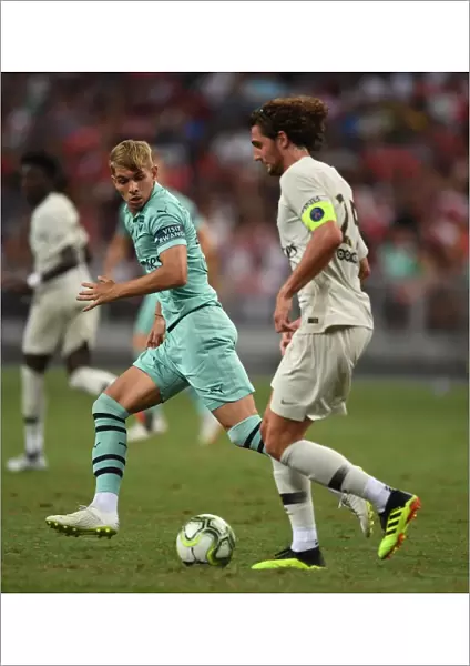 Arsenal's Emile Smith Rowe Clashes with Paris Saint-Germain's Adrien Rabiot in Pre-Season Friendly