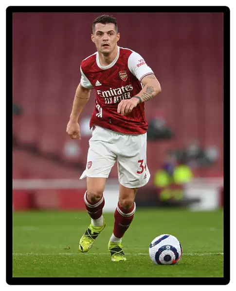Arsenal's Granit Xhaka in Action: 2021 Premier League Match vs. Manchester City at Emirates Stadium (Behind Closed Doors)