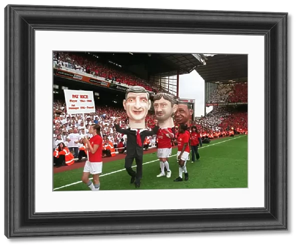 The Arsene Wenger and Tony Adams giant heads on the pitch during the final salute parade