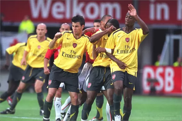 Arsenal wall (L>R) Cesc Fabregas, Alex Song and Justin Hoyte