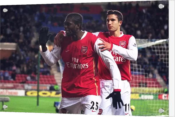 Emmanuel Adebayor celebrates scoring Arsenals goal with Robin van Persie