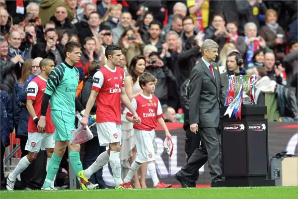 Arsene Wenger the Arsenal Manager and Robin van Persie (Arsenal) lead out the team