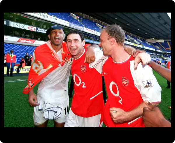 Thierry Henry, Martin Keown and Dennis Bergkamp (Arsenal) celebrate winning the league