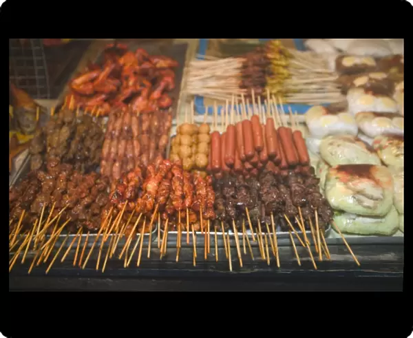 Malaysia, Sarawak, Sibu, grilled satay meat for sale at market stall, close-up