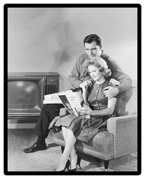 Couple looking at a magazine together
