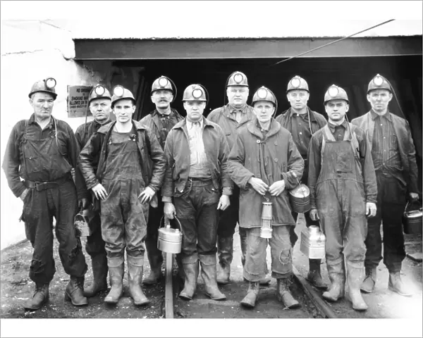 Coal miners at the entrance of a mine