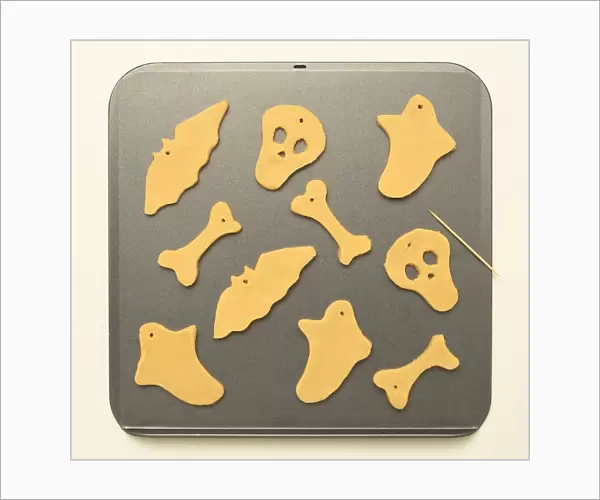 Halloween, ghostly shaped biscuits on a baking tray